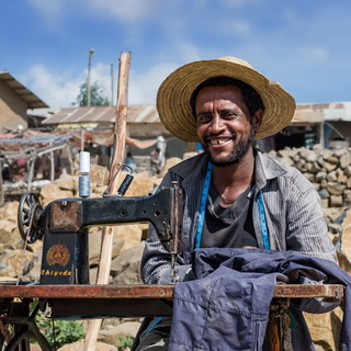 Debark - Man behind sewing machine